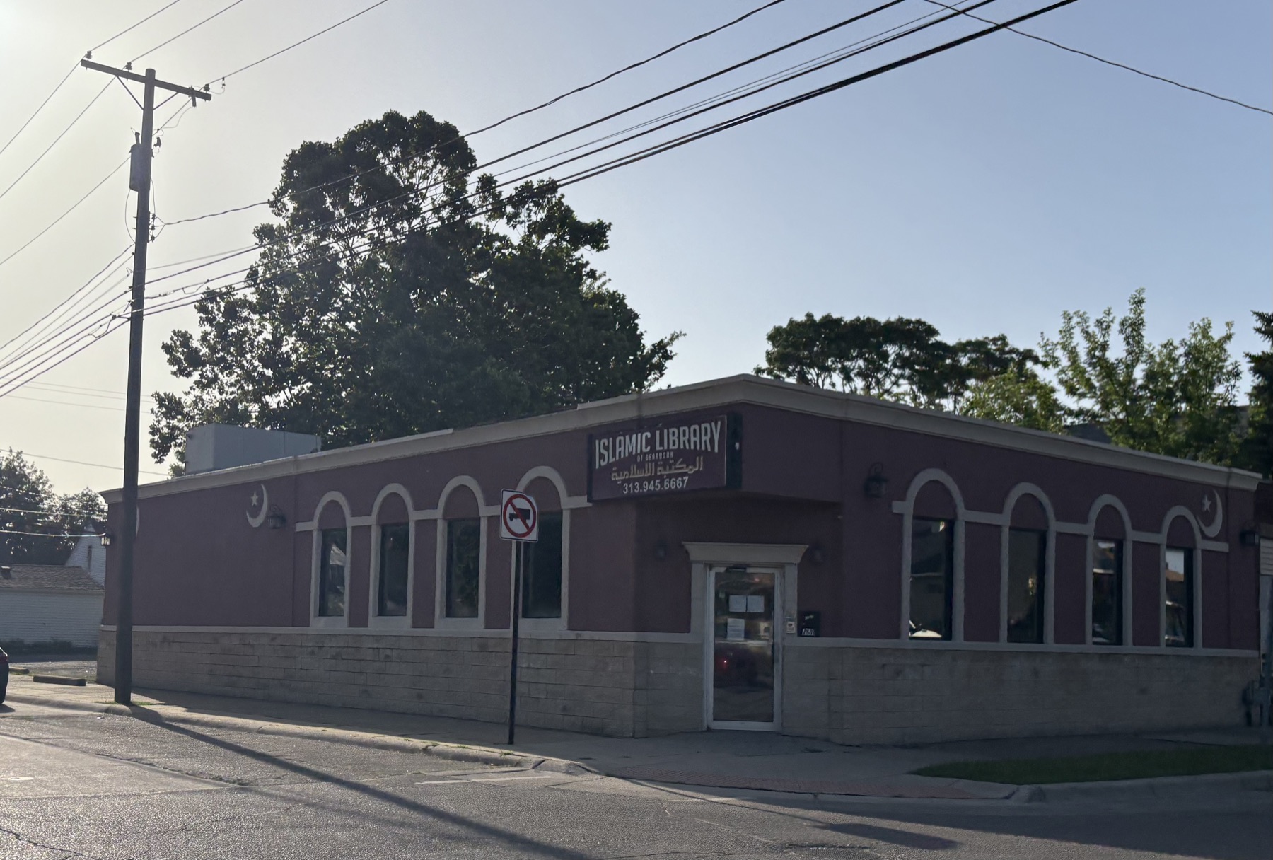 A single-storey building in Dearborn signed Islamic Library of Dearborn in English and Arabic, with crescent motifs on the facade.