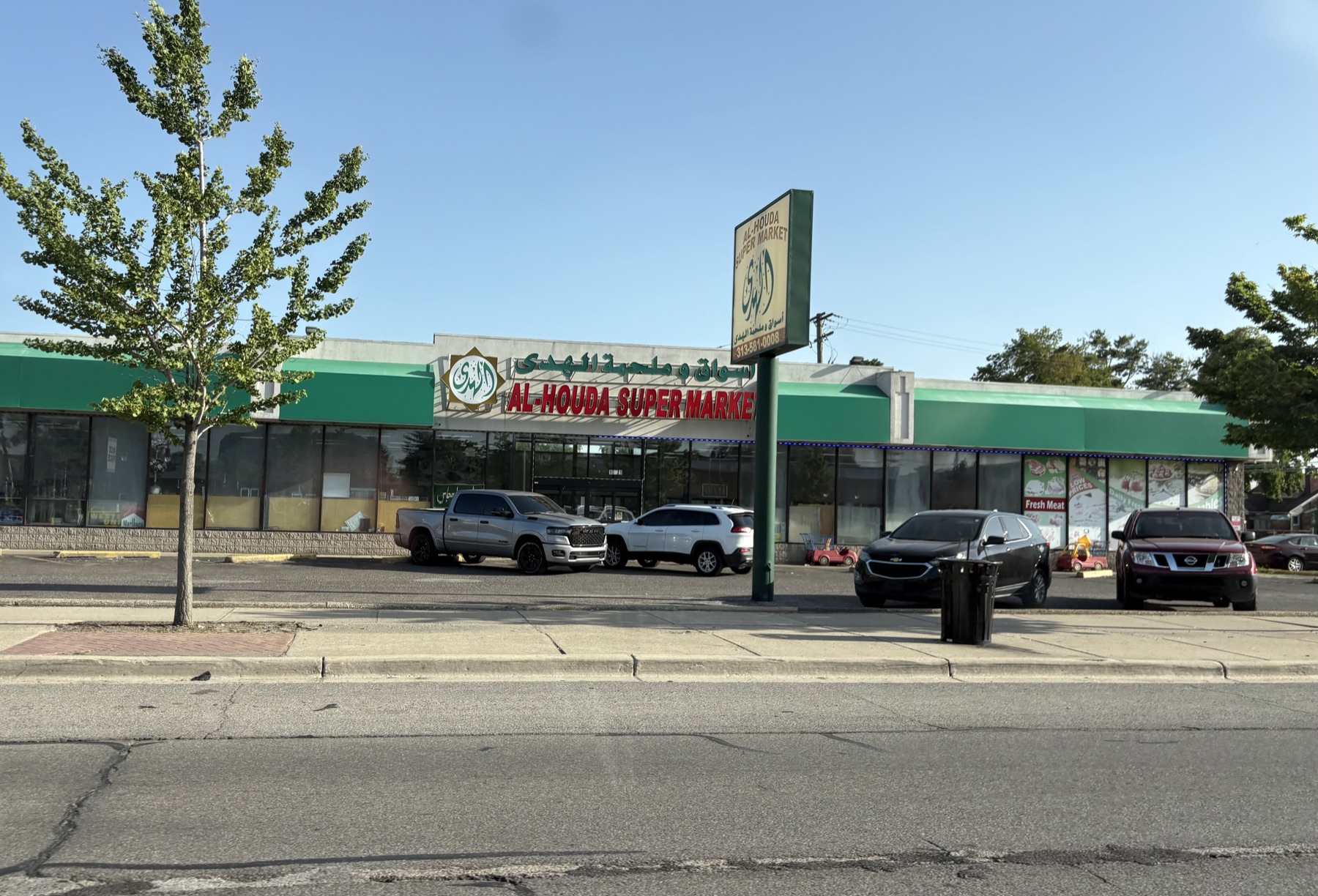 A grocery storefront in Dearborn with Arabic signage above the English name.