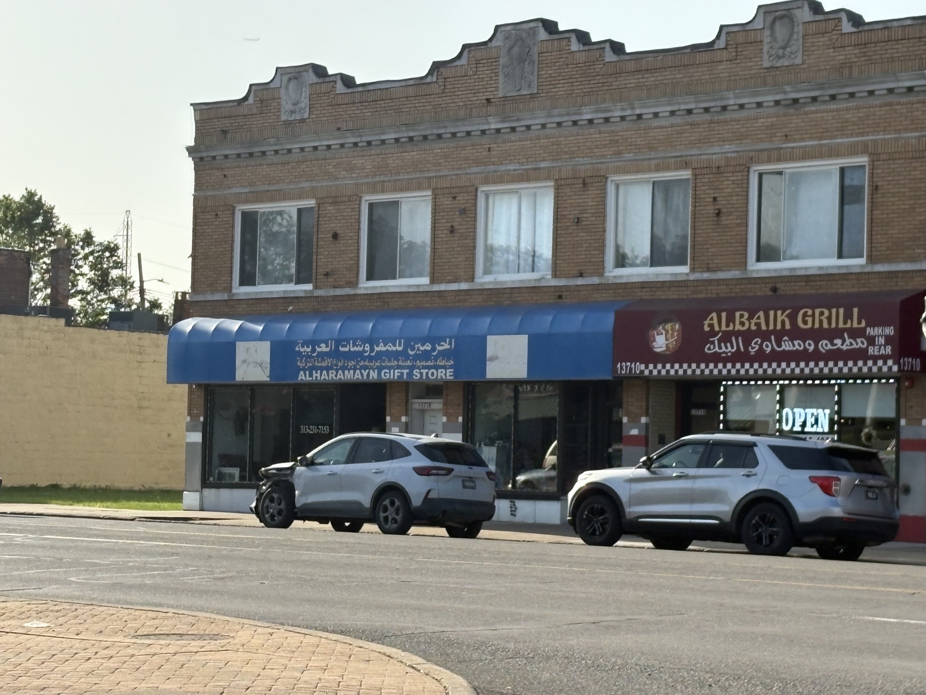 Two adjoining Dearborn businesses, a gift store and a grill, both signed in Arabic and English.